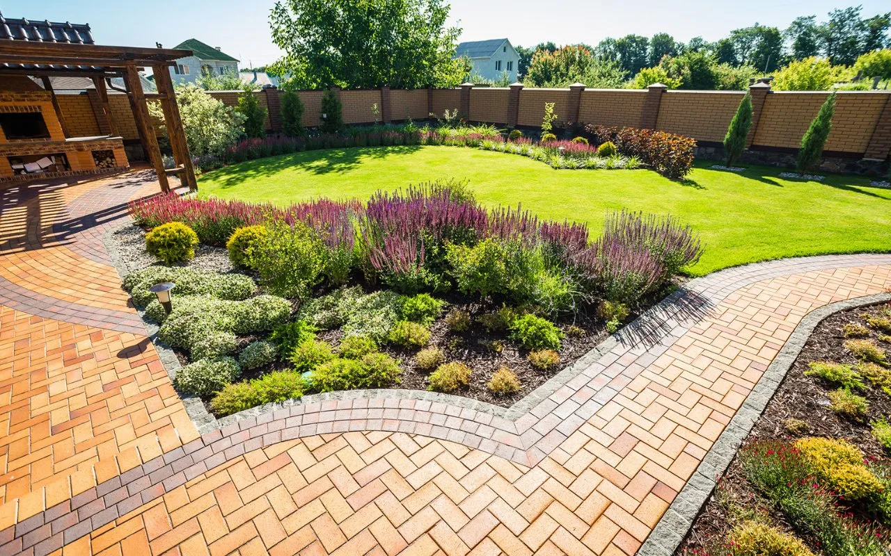 pavers and plants on a yard with a beautiful terrace - professional landscaping Utah