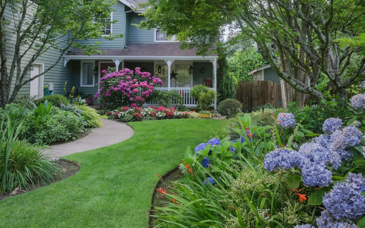 house with beautiful landscaping with trees, bushes and flowers - Professional Landscaping Utah